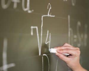 close-up-teacher-writing-chalkboard